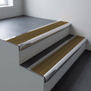 Polished aluminium bullnose stair nosing 66.5x30mm with Olive Castellated insert fitted on an office stair