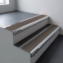 Polished aluminium bullnose stair nosing 66.5x30mm with Peat Castellated insert fitted on an office stair