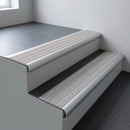 Aluminium bullnose stair nosing 66.5x30mm with Polar Grey Castellated insert fitted on an office stair