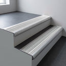 Mill aluminium bullnose stair nosing 66.5x30mm with Polar Grey Castellated insert fitted on an office stair