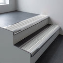 Polished aluminium bullnose stair nosing 66.5x30mm with Polar Grey Castellated insert fitted on an office stair