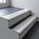 Mill aluminium bullnose stair nosing 66.5x30mm with Polar Grey Smooth Textured insert fitted on an office stair