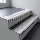 Polished aluminium bullnose stair nosing 66.5x30mm with Polar Grey Smooth Textured insert fitted on an office stair