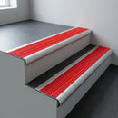 Aluminium bullnose stair nosing 66.5x30mm with Poppy castellated insert fitted on an office stair