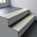 Mill aluminium bullnose stair nosing 66.5x30mm with Porth Stone Castellated insert fitted on an office stair