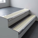 Polished aluminium bullnose stair nosing 66.5x30mm with Porth Stone Castellated insert fitted on an office stair