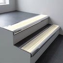 Polished aluminium bullnose stair nosing 66.5x30mm with Porth Stone Smooth Textured insert fitted on an office stair