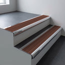 Polished aluminium bullnose stair nosing 66.5x30mm with Rustic Castellated insert fitted on an office stair