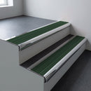 Polished aluminium bullnose stair nosing 66.5x30mm with Spruce Castellated insert fitted on an office stair