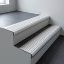 Aluminium bullnose stair nosing 66.5x30mm with White Castellated insert fitted on an office stair
