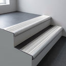 Mill aluminium bullnose stair nosing 66.5x30mm with White Castellated insert fitted on an office stair