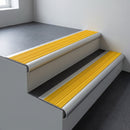 Aluminium bullnose stair nosing 66.5x30mm with Yellow Castellated insert fitted on an office stair
