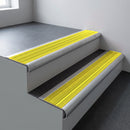 Mill aluminium bullnose stair nosing 66.5x30mm with Yellow Castellated insert fitted on an office stair