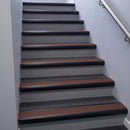 Black Anodised bullnose stair nosing 68x40mm with Claret Castellated insert, fitted to an interior stairwell
