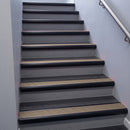 Black Anodised bullnose stair nosing 68x40mm with Fawn Castellated insert, fitted to an interior stairwell