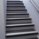 Black Anodised bullnose stair nosing 68x40mm with Polar Grey Castellated insert, fitted to an interior stairwell