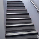 Black Anodised bullnose stair nosing 68x40mm with Polished Aluminium insert, fitted to an interior stairwell