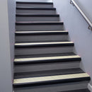 Black Anodised bullnose stair nosing 68x40mm with Porth Stone Castellated insert, fitted to an interior stairwell