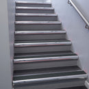 Polished Aluminium bullnose stair nosing 68x40mm with Black Olympic Grip insert, fitted to an interior stairwell