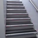 Polished Aluminium bullnose stair nosing 68x40mm with Black Smooth Textured insert, fitted to an interior stairwell