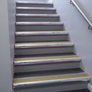 Polished Aluminium bullnose stair nosing 68x40mm with Light Bronze Aluminium insert, fitted to an interior stairwell