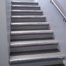 Polished Aluminium bullnose stair nosing 68x40mm with Light Grey Castellated insert, fitted to an interior stairwell