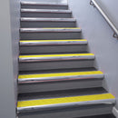 Polished Aluminium bullnose stair nosing 68x40mm with Yellow Castellated insert, fitted to an interior stairwell