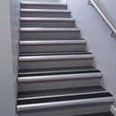Satin Aluminium bullnose stair nosing 68x40mm with Black Smooth Textured insert, fitted to an interior stairwell
