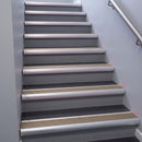 Satin Aluminium bullnose stair nosing 68x40mm with Fawn Castellated insert, fitted to an interior stairwell