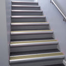 Satin Aluminium bullnose stair nosing 68x40mm with Light Bronze Aluminium insert, fitted to an interior stairwell