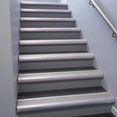 Satin Aluminium bullnose stair nosing 68x40mm with Light Grey Castellated insert, fitted to an interior stairwell