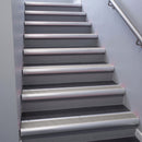 Satin Aluminium bullnose stair nosing 68x40mm with Light Grey Smooth Textured insert, fitted to an interior stairwell