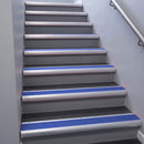 Satin Aluminium bullnose stair nosing 68x40mm with Mid Blue Castellated insert, fitted to an interior stairwell