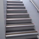Satin Aluminium bullnose stair nosing 68x40mm with Peat Castellated insert, fitted to an interior stairwell