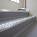 Aluminium bullnose stair nosing with an ice grey anti-slip insert fitted to mid-grey vinyl steps in a clinic stairwell
