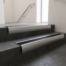 Aluminium bullnose stair nosing with Black Anodised Aluminium infill, fitted to concrete steps in a commercial stairwell