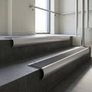 Aluminium bullnose stair nosing with Black Castellated PVC infill, fitted to concrete steps in a commercial stairwell