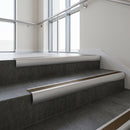 Aluminium bullnose stair nosing with Bronze Anodised Aluminium infill, fitted to concrete steps in a commercial stairwell