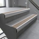 Aluminium bullnose stair nosing with Fawn Castellated PVC infill, fitted to concrete steps in a commercial stairwell