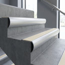 Aluminium bullnose stair nosing with Ivory Castellated PVC infill, fitted to concrete steps in a commercial stairwell