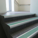 Aluminium bullnose stair nosing with Jade Castellated PVC infill, fitted to concrete steps in a commercial stairwell