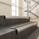 Aluminium bullnose stair nosing with Light Bronze Anodised Aluminium infill, fitted to concrete steps in a commercial stairwell