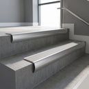 Aluminium bullnose stair nosing with Light Grey Smooth Textured PVC infill, fitted to concrete steps in a commercial stairwell