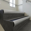 Mill Aluminium bullnose stair nosing with Black Smooth Textured PVC infill, fitted to concrete steps in a commercial stairwell