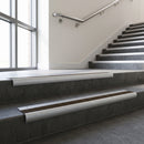 Mill Aluminium bullnose stair nosing with Bronze Anodised Aluminium infill, fitted to concrete steps in a commercial stairwell