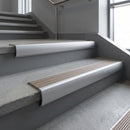 Mill Aluminium bullnose stair nosing with Fawn Castellated PVC infill, fitted to concrete steps in a commercial stairwell