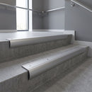 Aluminium bullnose stair nosing with Plain Mill Aluminium infill, fitted to concrete steps in a commercial stairwell