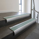 Mill Aluminium bullnose stair nosing with Jade Castellated PVC infill, fitted to concrete steps in a commercial stairwell