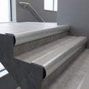 Mill Aluminium bullnose stair nosing with Light Grey Smooth Textured PVC infill, fitted to concrete steps in a commercial stairwell