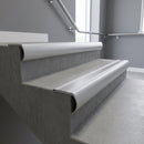 Mill Aluminium bullnose stair nosing with Plain Mill Aluminium infill, fitted to concrete steps in a commercial stairwell